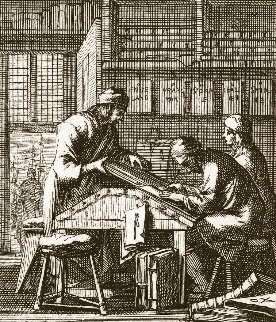 De Koopman, The Merchant: a clerk pen in hand at a sloped writing desk in a merchant’s counting house, the letter-racks above him labeled for England, France, Spain, Italy, and Smyrna, a balance hanging on the wall, a strapped account book beneath the table, the harbor seen through the window; an etching by Jan and Caspar Luyken from the Book of Trades, Amsterdam, 1694. Rijksmuseum.